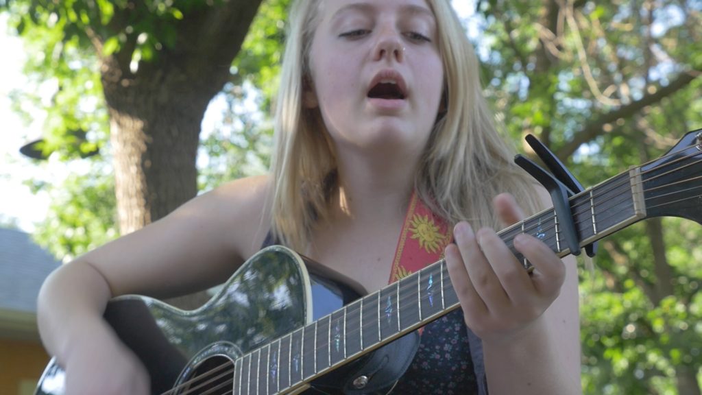 Young musician singing outdoors